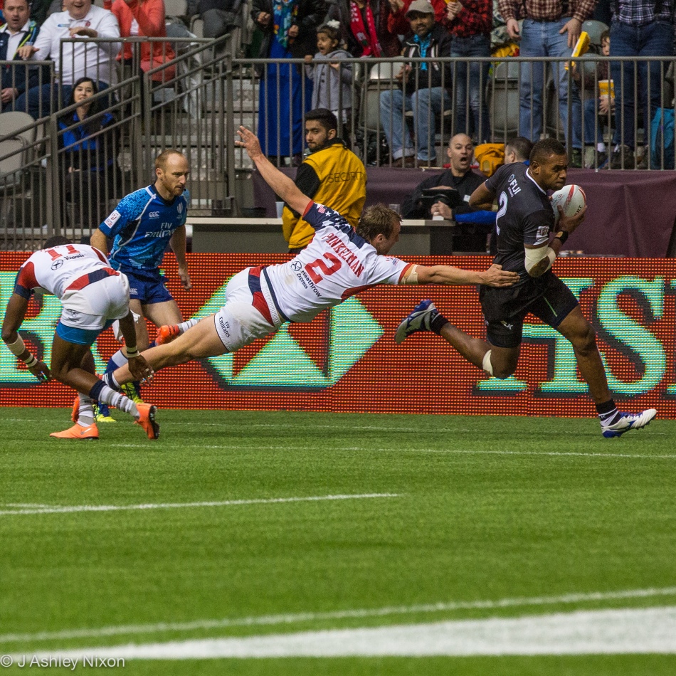 2 on 2. Fiji's Jasa Veremalua makes it to the try line despite Ben Pinkelman's superman heroics for USA in the HSBC Rugby Sevens at BC Place, Vancouver. © J. Ashley Nixon